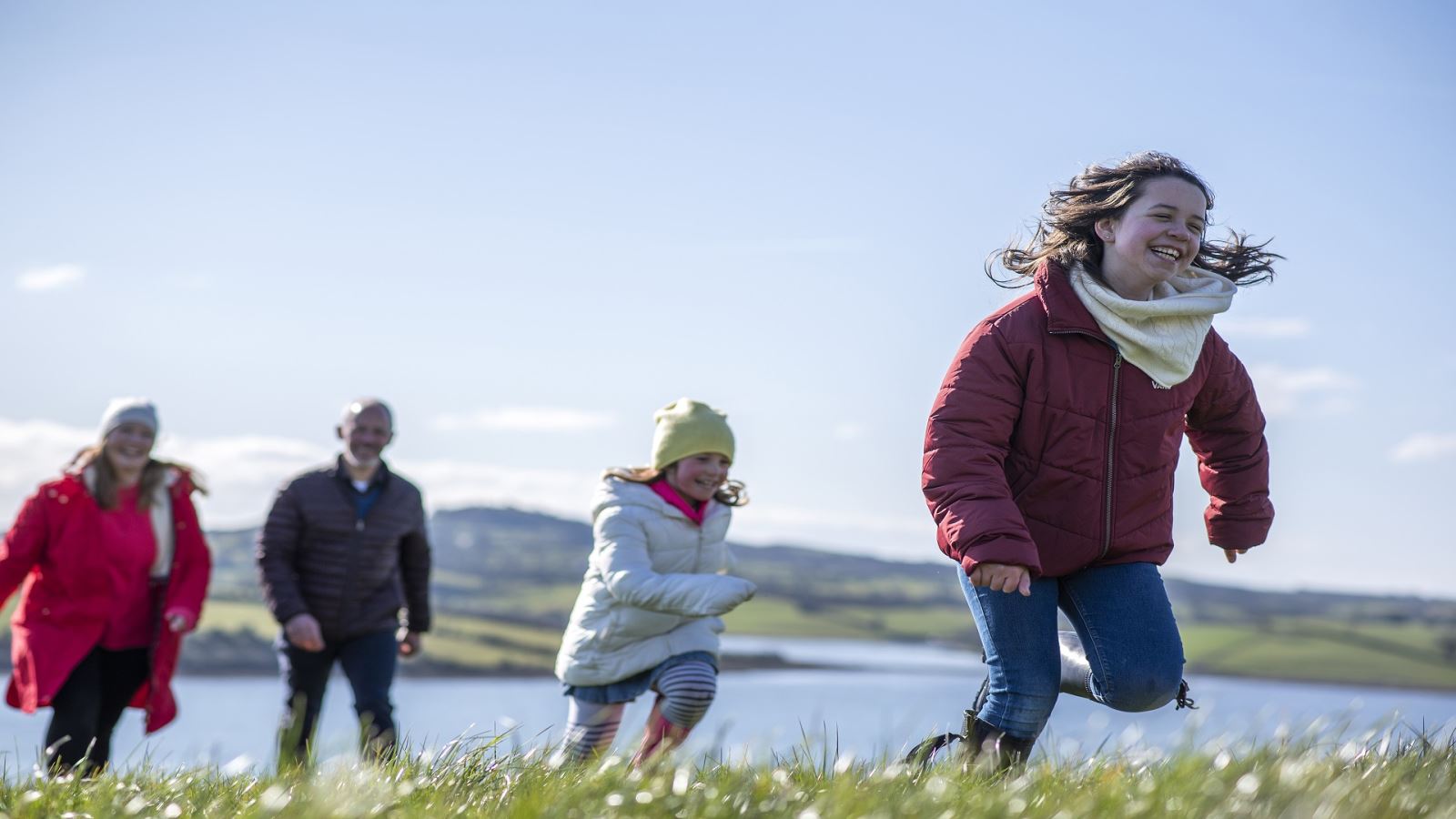 Family running in Delamont Country Park